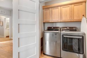 a kitchen with a refrigerator and a stove at Mayflower Lakeside 303-14 by Moose Management in Cranmer