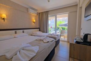 Postel nebo postele na pokoji v ubytování Moni Hotel