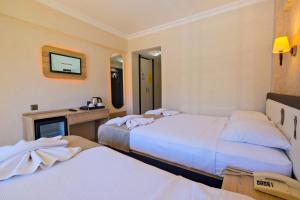 Postel nebo postele na pokoji v ubytování Moni Hotel