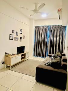 a bedroom with a bed and a tv and a window at Sutera Luxurious Loft 1 in Kota Kinabalu