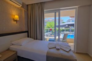 Postel nebo postele na pokoji v ubytování Moni Hotel