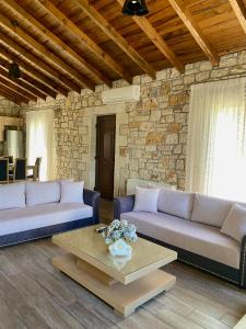 a living room with two couches and a coffee table at Villa Maria 1 in Gliki