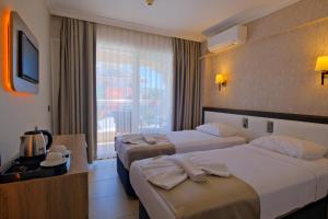 Postel nebo postele na pokoji v ubytování Moni Hotel