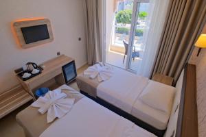 Postel nebo postele na pokoji v ubytování Moni Hotel