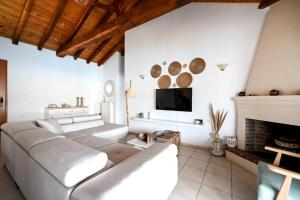 a living room with a couch and a fireplace at Villa Lazareta in Punta