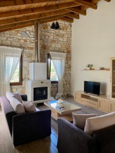 sala de estar con 2 sofás y chimenea en Villa Maria 1, en Gliki