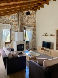a living room with two couches and a fireplace at Villa Maria 1 in Gliki +20 photos