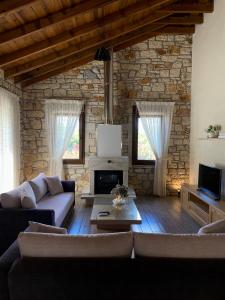 a living room with a couch and a fireplace at Villa Maria 1 in Gliki