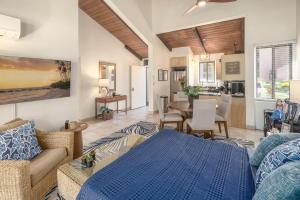 a living room with a couch and a dining room at Kamaole Sands 7-100 in Wailea