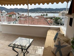 a balcony with a couch and a view of the water at 8 oDa Marmaris in Marmaris