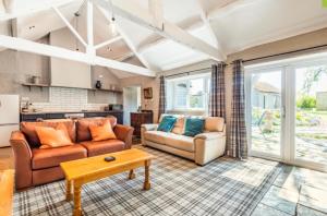 a living room with two couches and a table at Octon Cottages Luxury 1 and 2 Bedroom cottages 1 mile from Taunton centre in Taunton