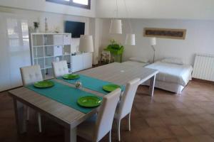 a dining table and chairs in a living room at Charming studio in La Massimina, 45 m² with private garden in La Massimina-Casal Lumbroso