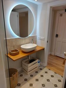 a bathroom with a sink and a mirror at Casona del Sol El Retorno II - RECIEN REFORMADO in Lastres