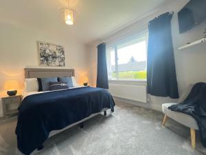 um quarto com uma cama, uma janela e uma cadeira em Mountain View Bungalow em Newcastle