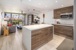 a kitchen with a large white island in a room at Kamaole Sands 3-303 in Wailea