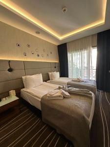 a hotel room with two beds and a window at Cihangir Hotel Bosphorus in Istanbul +37 photos
