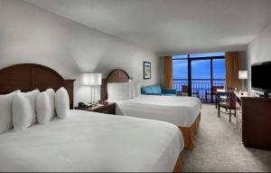 a hotel room with two beds and a balcony at Best Western Ocean Sands Beach Resort in Myrtle Beach