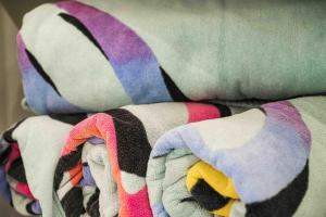 a colorful blanket laying on top of a bed at Kamaole Sands 3-303 in Wailea +38 photos