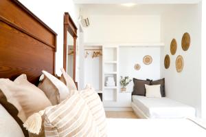 a bedroom with a bed with pillows and a couch at Laza Beach in Skala +37 photos
