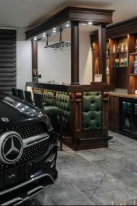 a bar with a car parked in a room at Villa Paradiso - Detached in Manikata