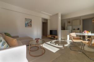 a living room with a couch and a table at Kallisti Stay in Artemida