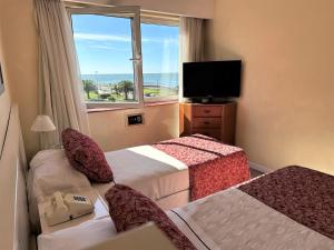 a hotel room with two beds and a window at Hotel Guerrero in Mar del Plata +21 photos