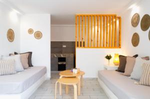 a living room with two white couches and a table at Laza Beach in Skala