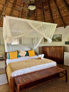 a bedroom with a bed with a canopy at Ku Sungula Safari Lodge in Balule Game Reserve
