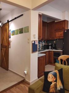 een keuken met een woonkamer met een bank bij Kasoni Home , Απόλυτα κεντρικό διαμέρισμα μπροστά στη λίμνη in Kastoria