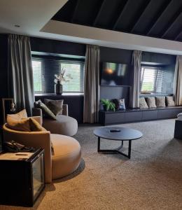 a living room with two couches and a table at Parkhotel Horst - Venlo in Horst