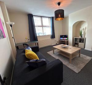 a living room with a couch and a coffee table at 82a Underwood Lane in Crewe