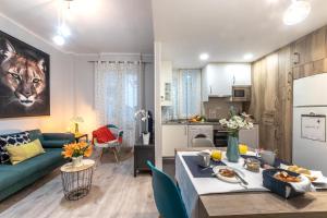 a living room and kitchen with a couch and a table at INSIDE OLD TOWN by Eba Homes in Bilbao