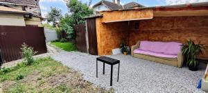 a backyard patio with a couch and a table at Matei Apartament in Tîrnăveni +1 photo
