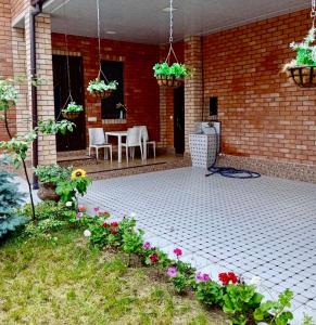 a patio with flowers and a table and chairs at Chaqar in Tashkent