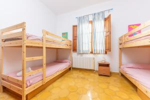 a room with two bunk beds in a house at Can Mir in Alcudia