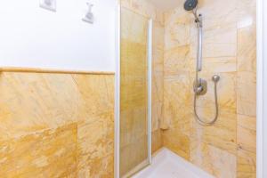 a shower with a glass door in a bathroom at Can Mir in Alcudia +38 photos