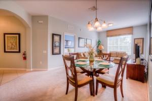 a dining room and living room with a table and chairs at Vista Cay Condo w FREE Resort Access, near Disney in Orlando