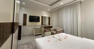 a hotel room with a bed and a television at تمايا الخبر Tamaya Alkhobar in Al Khobar