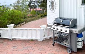 a bbq grill on a patio next to a house at Nice Home In Alingss With Lake View in Alingsås
