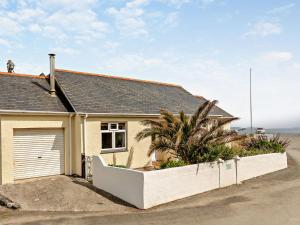 a house with a fence in front of it at 2 bed in Porthallow LPEBB in Porthallow