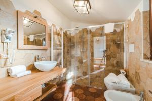 a bathroom with a sink and a glass shower at Seguire Le Botti - Agriturismo Cantina Sant'Andrea in Borgo Vodice