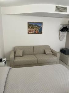 a living room with a couch and a bed at Amalfi Suite Boutique Hotel in Amalfi