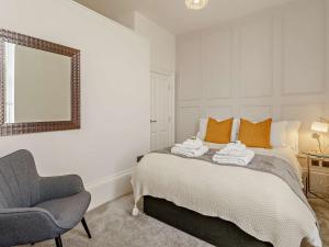 a bedroom with a bed and a chair and a mirror at 1 Bed in Carlisle 92869 in Carlisle