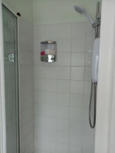 a bathroom with a shower with a phone on the wall at Masons Arms in York