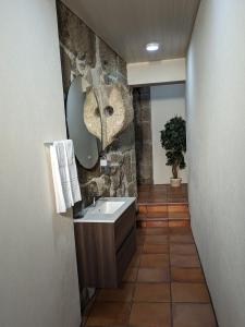 a bathroom with a sink and a mirror at Casa de Ladrido in Felgueiras