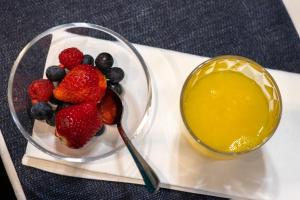a bowl of fruit and a bowl of orange juice at INSIDE OLD TOWN by Eba Homes in Bilbao
