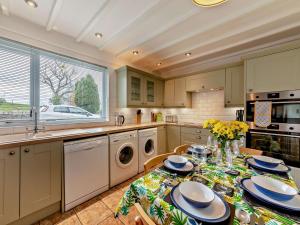 a kitchen with a table with plates on it at 3 Bed in Alnwick 93171 in Edlingham