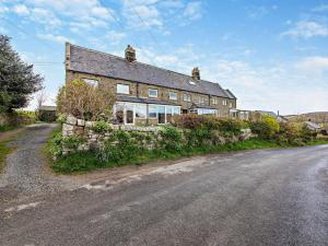 an old house on the side of a road at 3 Bed in Alnwick 93171 in Edlingham