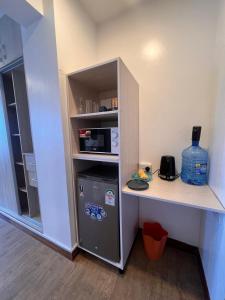 a kitchen with a counter and a small refrigerator at SPACIOUS STUDIO IN NYALI with AC opposite voyager resort RITZ APARTMENT in Mombasa