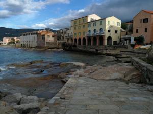 a group of buildings next to a body of water at Algajola in Algajola